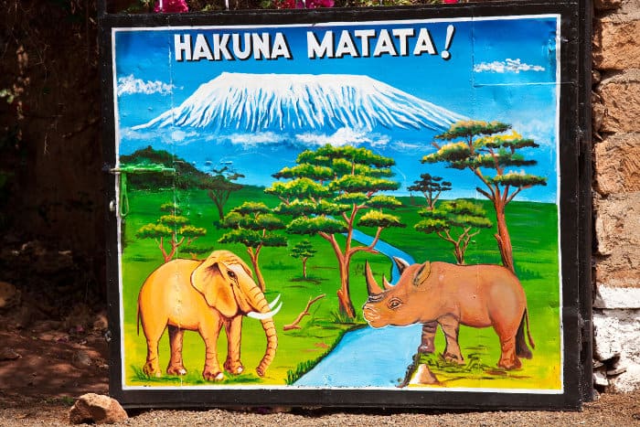 Hakuna matata sign, with elephant (tembo) and rhino (kifaru) in front of the Kilimanjaro