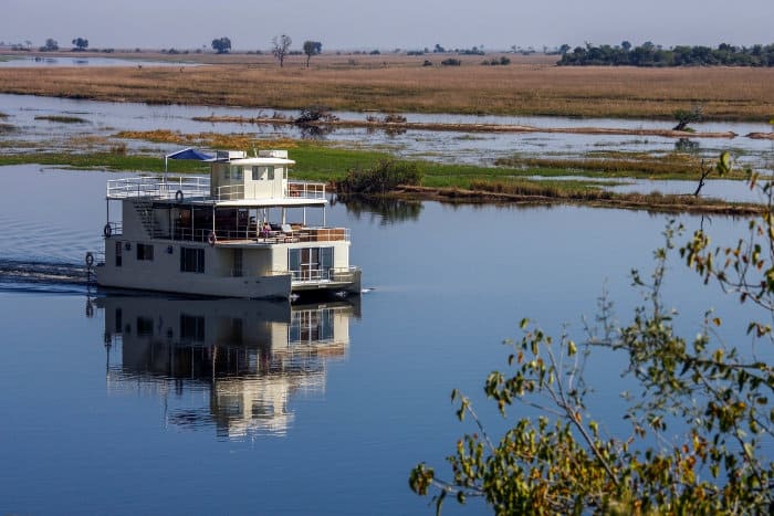 House boat cruising along the Chobe River in Botswana