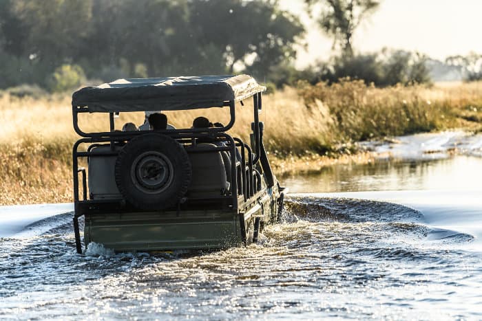 Land cruiser passing through water in the Delta