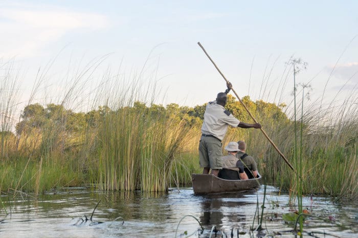 Tourists on a mokoro safari in the Okavango