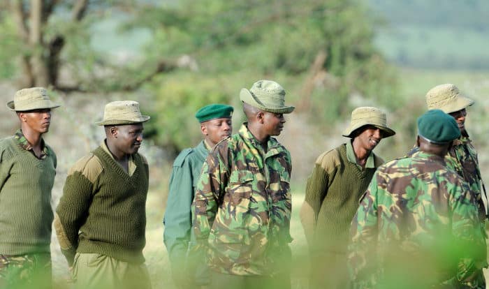 Group of game rangers being briefed for the day, Masai Mara