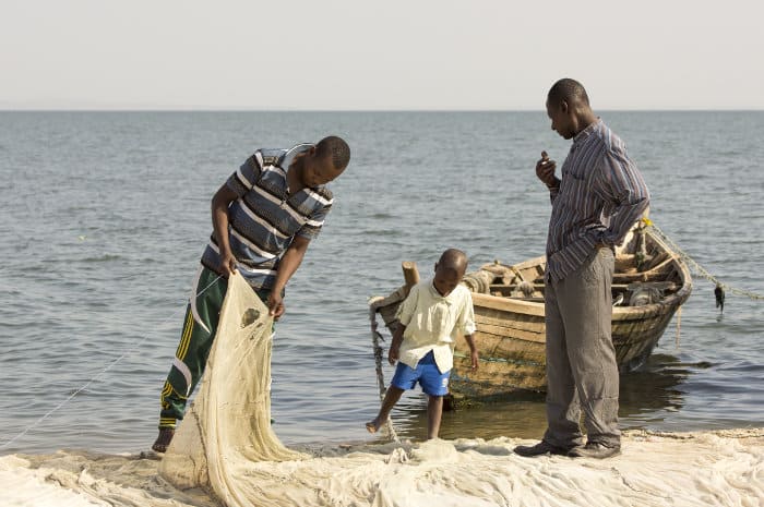 Two fishermen inspecting their nets, Speke Bay, Lake Victoria