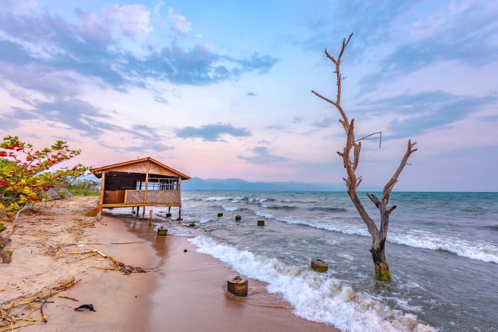 Wooden house on stilts, standing partly in water, Lake Tanganyika