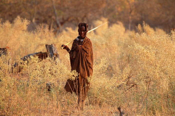 Young Himba looking after cattle in the Namibian bush